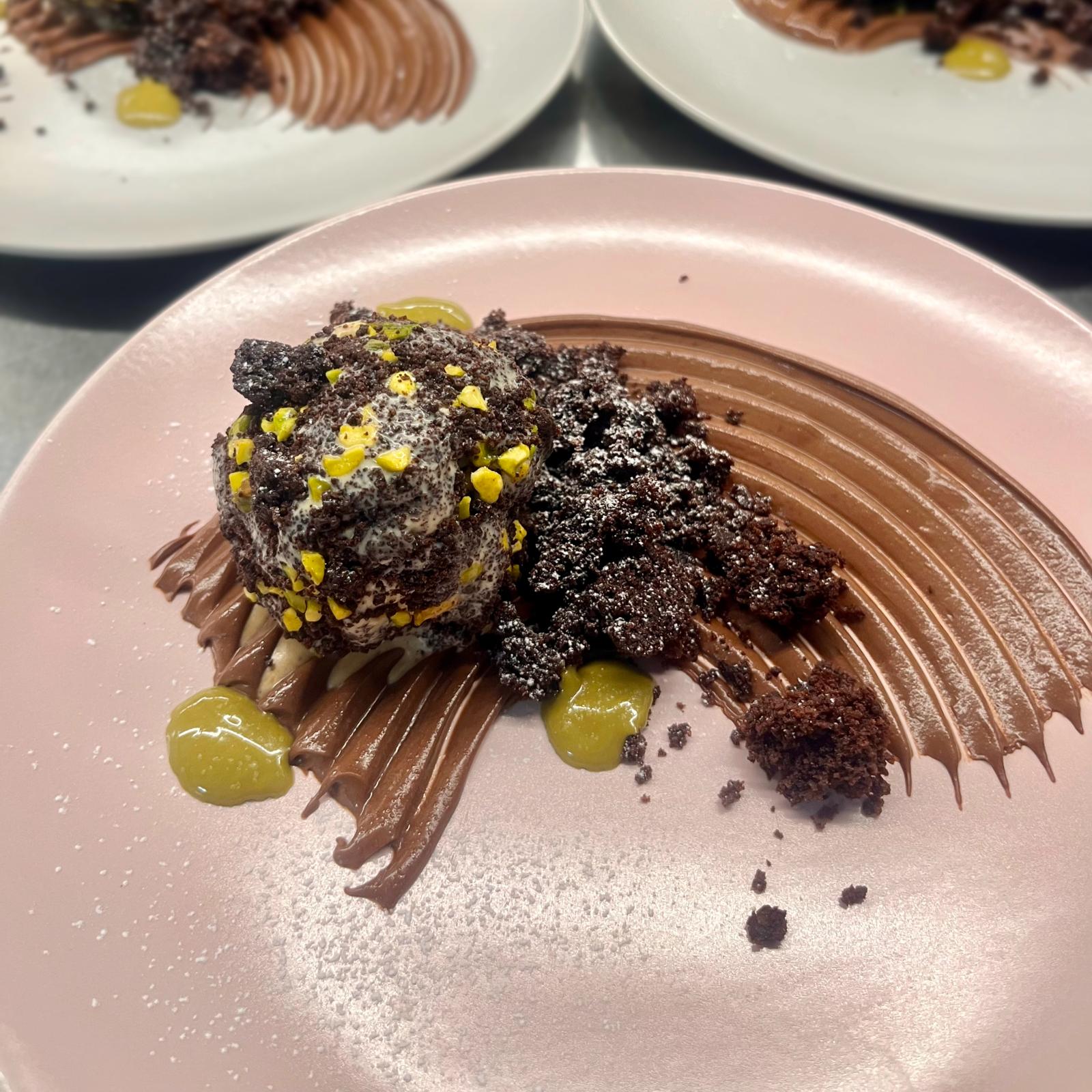Cocoa cake with pistachio ice cream, mousse and dark chocolate crumble